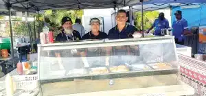 SEQIA members, Nazrul Ali, Nazia Ali, Aiyub Mohammed working in the South East Qld Community Centre Food Stall